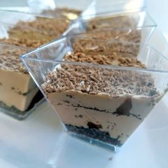 A picture of Nutella mousse cups with Oreo and ganache.