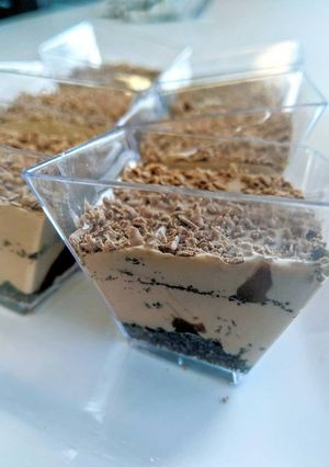 A picture of Nutella mousse cups with Oreo and ganache.