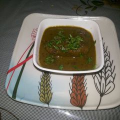 A picture of Kamal kakdi kofta in palak gravy.