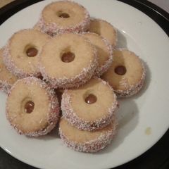 A picture of Jam tarts with coconut.