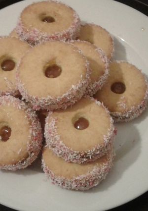 A picture of Jam tarts with coconut.