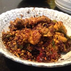 A picture of Dry Chicken with curry leaves and red chillies.