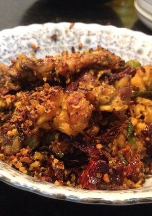 A picture of Dry Chicken with curry leaves and red chillies.
