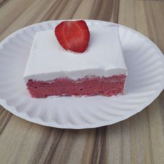 A picture of Strawberry milk cake with whipped cream frosting.