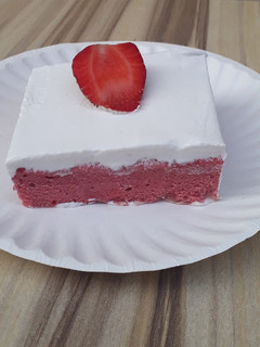 A picture of Strawberry milk cake with whipped cream frosting.