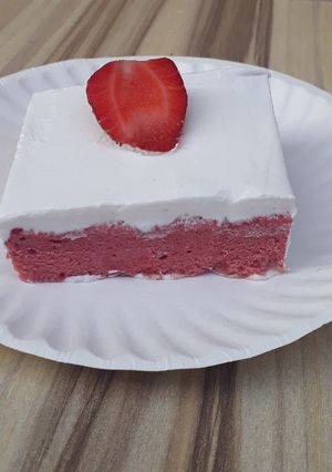 A picture of Strawberry milk cake with whipped cream frosting.