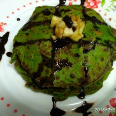 Palak pan cake with chocolate syrup A picture of Palak pan cake with chocolate syrup.
