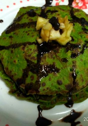 A picture of Palak pan cake with chocolate syrup.