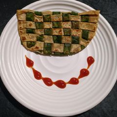 A picture of Green veggies stuffed chatai paratha.