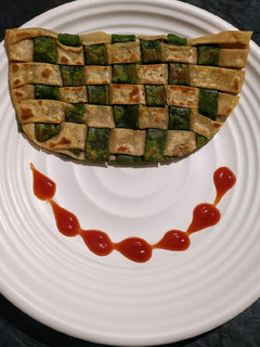 A picture of Green veggies stuffed chatai paratha.