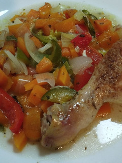 Una foto de Pollo al horno especiado con colchón de vegetales