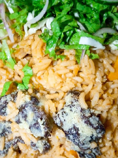 A picture of Native Jollof rice with salad.
