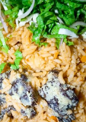A picture of Native Jollof rice with salad.