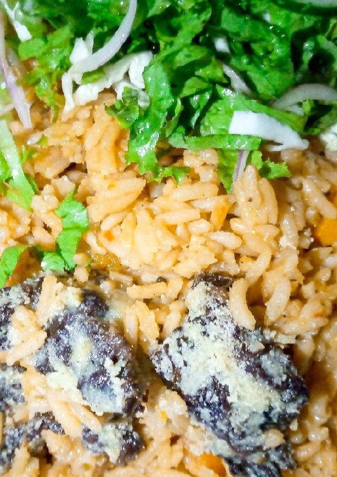 A picture of Native Jollof rice with salad.
