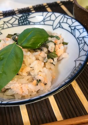 A picture of Salmon Sushi with Fresh Basil.