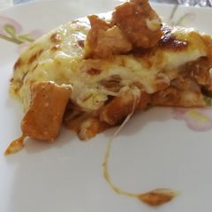 A picture of Chicken and tomato lasagne with bechamel sauce.
