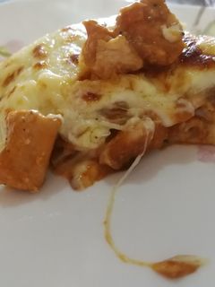A picture of Chicken and tomato lasagne with bechamel sauce.