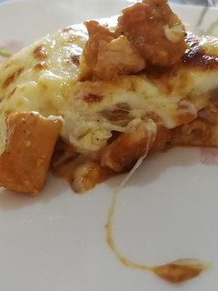 A picture of Chicken and tomato lasagne with bechamel sauce.