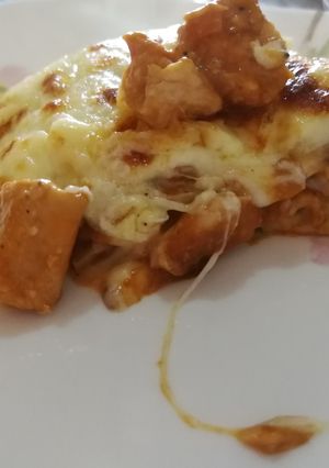 A picture of Chicken and tomato lasagne with bechamel sauce.