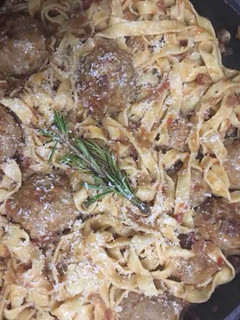 A picture of Pork and beef meatballs in a slow braised tomato sauce and pasta.