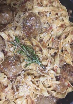 A picture of Pork and beef meatballs in a slow braised tomato sauce and pasta.