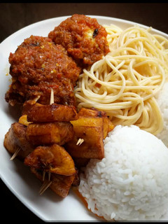 A picture of Rice,spagetti fried plantain with beef.