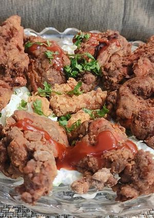 A picture of Crispy fried chicken on creamy lettuce bed.
