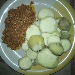 A picture of Boiled sweet potatoes and egg sauce.