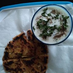 A picture of Makki ka parantha & brinjal Raita.