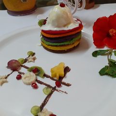 A picture of Rainbow pancakes with icecream.