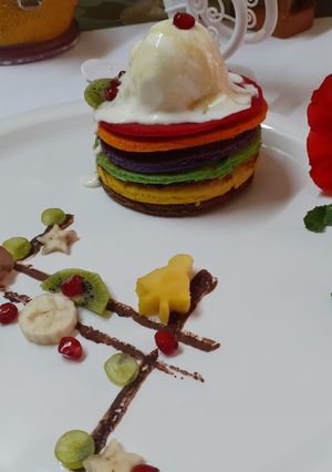 A picture of Rainbow pancakes with icecream.