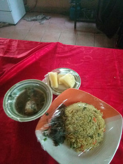A picture of Fish pepper soup,fried rice with liver souce nd pineapplesegment.