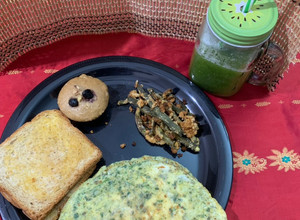 A picture of English breakfast(whole wheat blueberry walnut muffin omelette airfried beans and cucumber juice).
