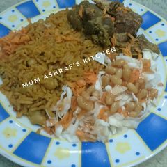 A picture of Jallof rice wit cabbage salad.