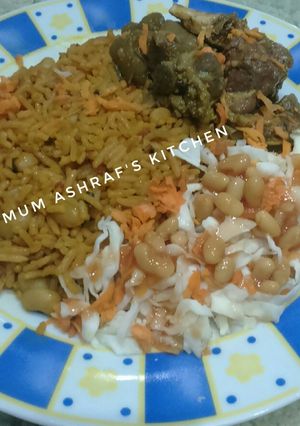 A picture of Jallof rice wit cabbage salad.