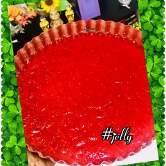 A picture of Strawberry & banana jelly dessert with seeds & nuts.
