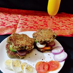 A picture of Oats sprouted beans sandwich with fresh orange juice.