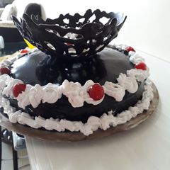A picture of Chocolate mirror glaze malai cake.