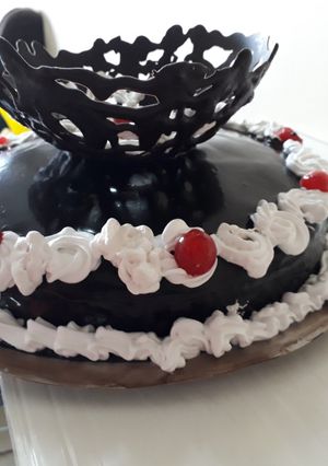 A picture of Chocolate mirror glaze malai cake.