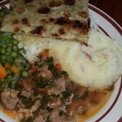 A picture of Mashed Potatoes Served with Beef,peas stew, Chapati and rice.