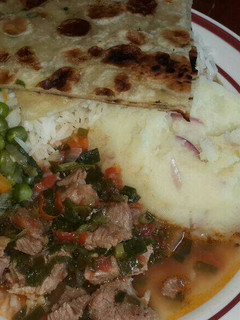 A picture of Mashed Potatoes Served with Beef,peas stew, Chapati and rice.