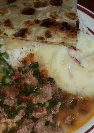 A picture of Mashed Potatoes Served with Beef,peas stew, Chapati and rice.