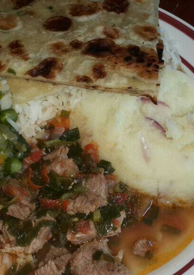 A picture of Mashed Potatoes Served with Beef,peas stew, Chapati and rice.
