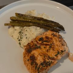A picture of Pan-seared salmon with mashed potatoes and roasted asparagus.