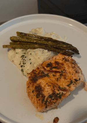 A picture of Pan-seared salmon with mashed potatoes and roasted asparagus.