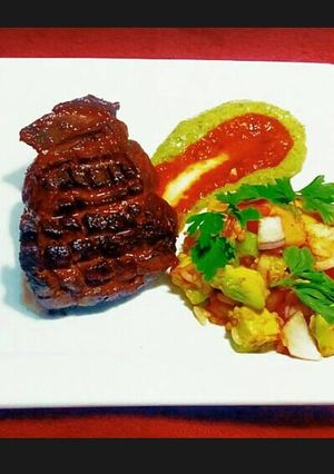 A picture of Steak on Avocado Puree and Mango Slaw.