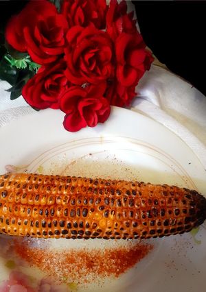 A picture of Garma garam saikha hoa bhutta/ corn on the cob In stove flame.