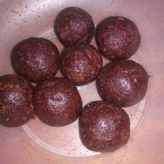 A picture of Red jam and cake crumbs balls.