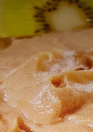 A picture of Peanut butter dip and fruit slices.