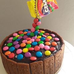 A picture of Gems Chocolate Cake for kids | Atta fruit and nut cake.